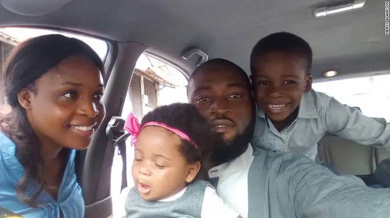 Joe Blankson in a car with his wife and their two young children